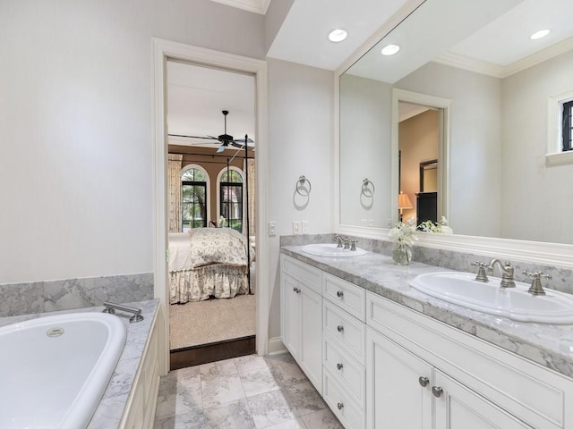 2646 Cardinal Dr, Vero Beach, FL 32963 - ensuite bathroom featuring ceiling fan, double vanity, ornamental molding, tiled tub, and recessed lighting