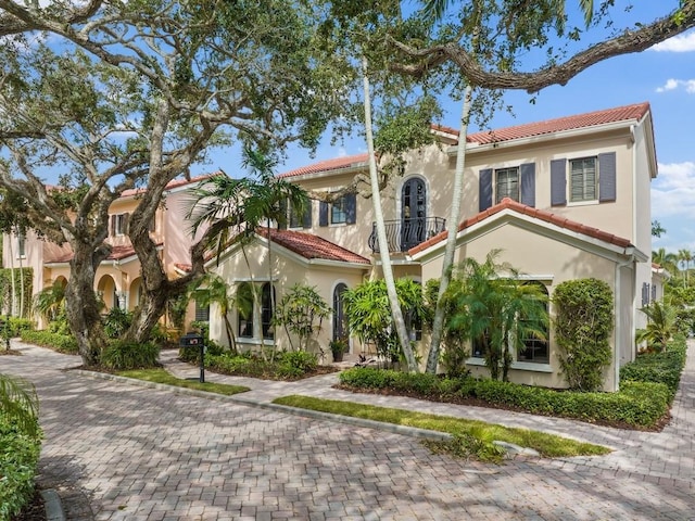 2646 Cardinal Dr, Vero Beach, FL 32963 - mediterranean / spanish house featuring a balcony, a tiled roof, and stucco siding