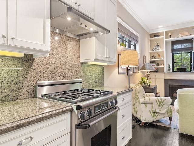 kitchen featuring dark hardwood / wood-style flooring, white cabinetry, stainless steel stove, and crown molding