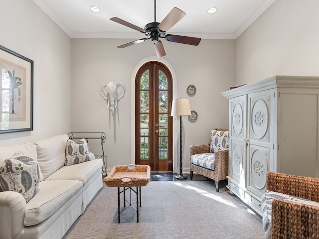 sitting room featuring ceiling fan and crown molding