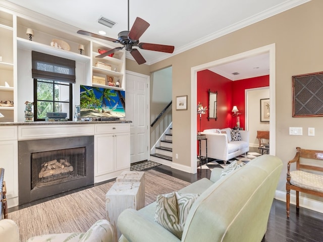 living room with ceiling fan, dark hardwood / wood-style floors, and crown molding