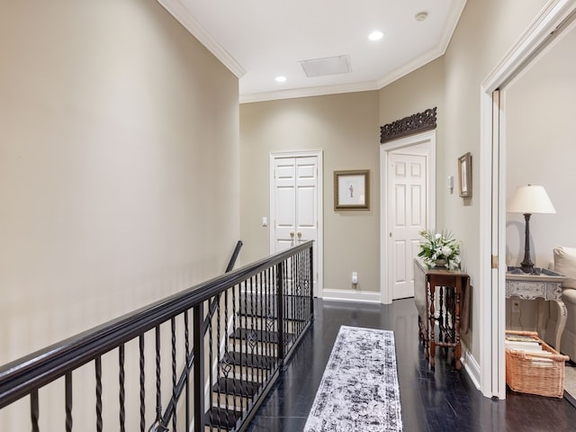 corridor with dark wood-type flooring and ornamental molding