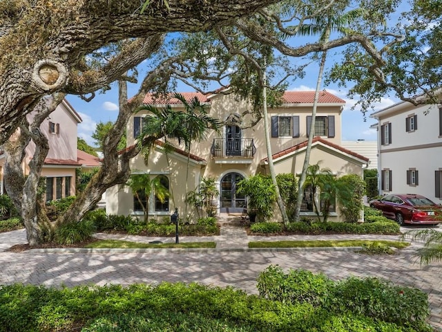2646 Cardinal Dr, Vero Beach, FL 32963 - mediterranean / spanish-style home featuring a balcony, stucco siding, and a tile roof
