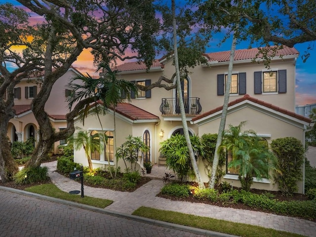 2646 Cardinal Dr, Vero Beach, FL 32963 - mediterranean / spanish house with a balcony, a tiled roof, and stucco siding