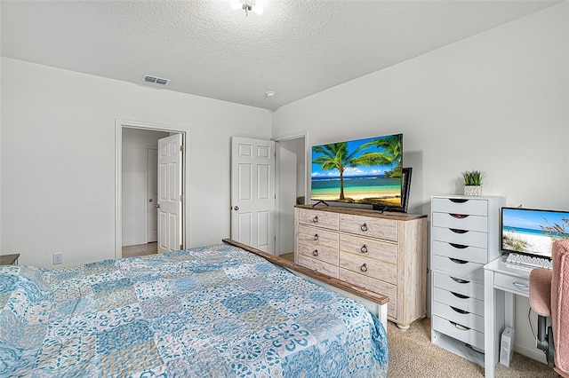 carpeted bedroom with a textured ceiling