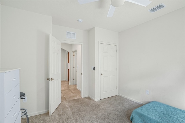 bedroom with light carpet and ceiling fan