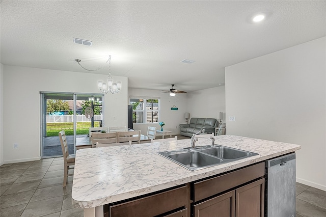 kitchen with sink, a center island with sink, light tile patterned floors, stainless steel dishwasher, and pendant lighting