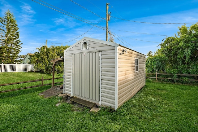 view of outbuilding with a yard