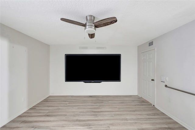 interior space featuring ceiling fan, a textured ceiling, and light wood-type flooring