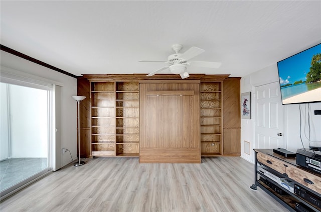 unfurnished living room featuring ceiling fan, light hardwood / wood-style flooring, and crown molding