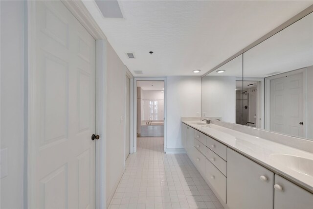 bathroom featuring tile patterned flooring and vanity