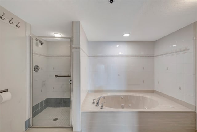 bathroom featuring shower with separate bathtub