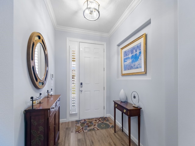 foyer entrance featuring light hardwood / wood-style flooring and ornamental molding