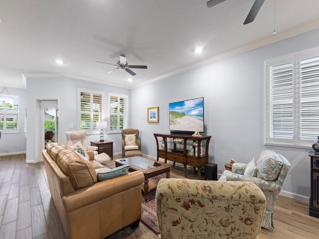 living room featuring ceiling fan, a textured ceiling, crown molding, and light hardwood / wood-style flooring