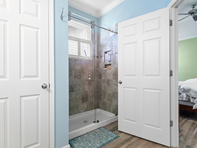 bathroom featuring an enclosed shower, wood-type flooring, and crown molding