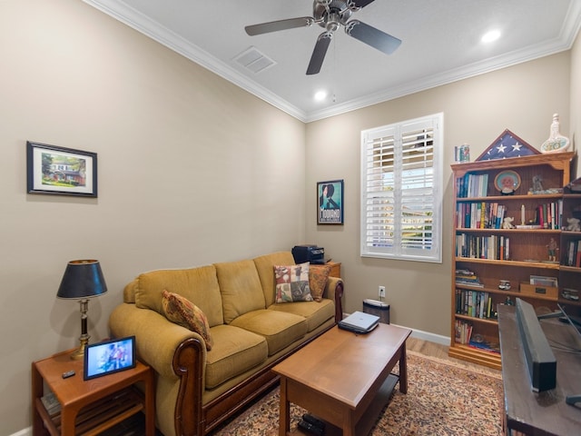 living room with hardwood / wood-style flooring, ceiling fan, and crown molding