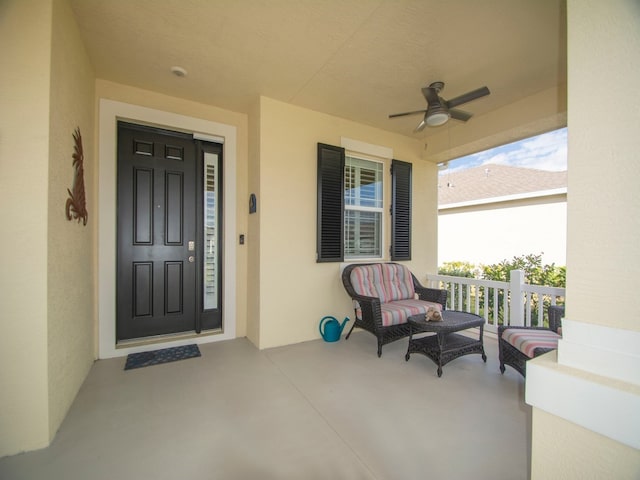 property entrance with a porch and ceiling fan