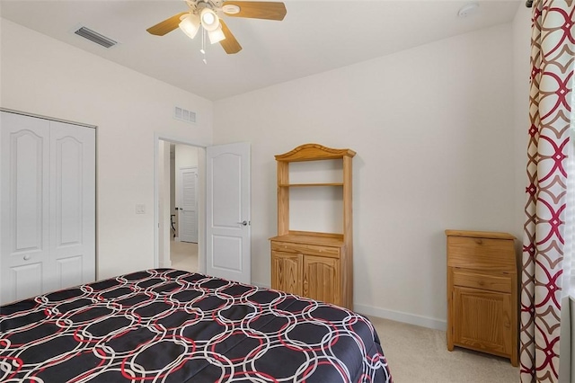 bedroom featuring ceiling fan, a closet, and light carpet