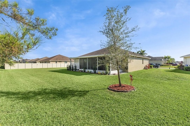 view of yard with a sunroom