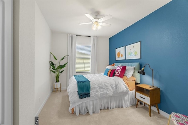 bedroom with light colored carpet and ceiling fan