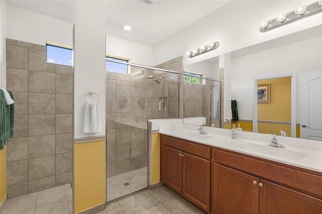 bathroom featuring tile patterned floors, vanity, and a shower with door