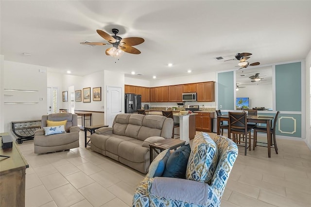 tiled living room featuring ceiling fan