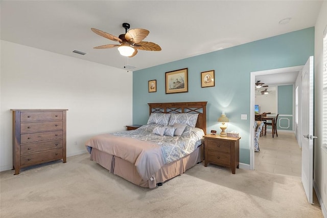 bedroom featuring light carpet and ceiling fan