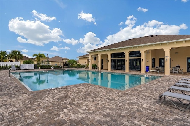 view of pool with ceiling fan and a patio area