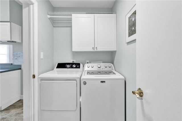 washroom featuring cabinet space and washing machine and dryer