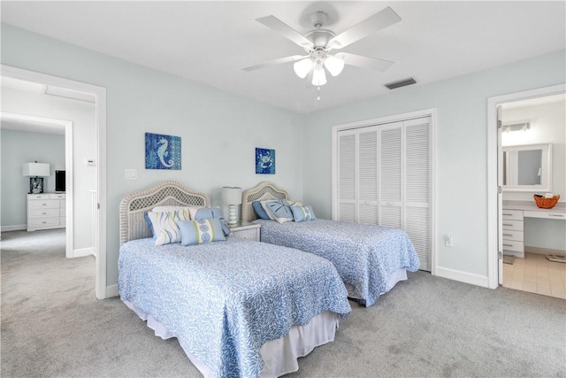 bedroom featuring a closet, carpet flooring, visible vents, and baseboards