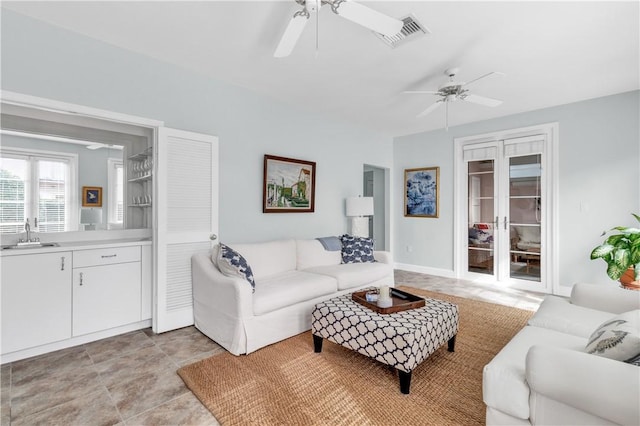 living room with visible vents and ceiling fan