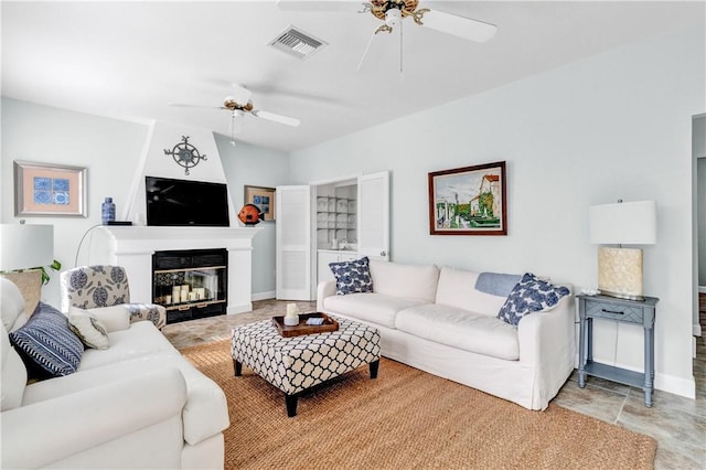 living room with ceiling fan, visible vents, baseboards, and a multi sided fireplace