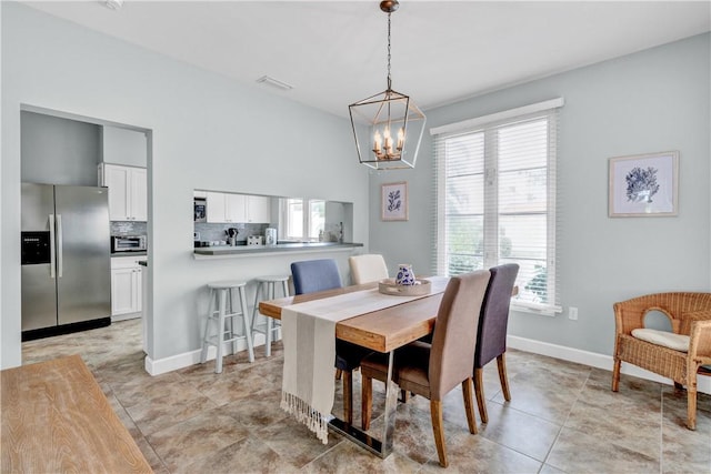 dining area with a chandelier, visible vents, baseboards, and light tile patterned floors