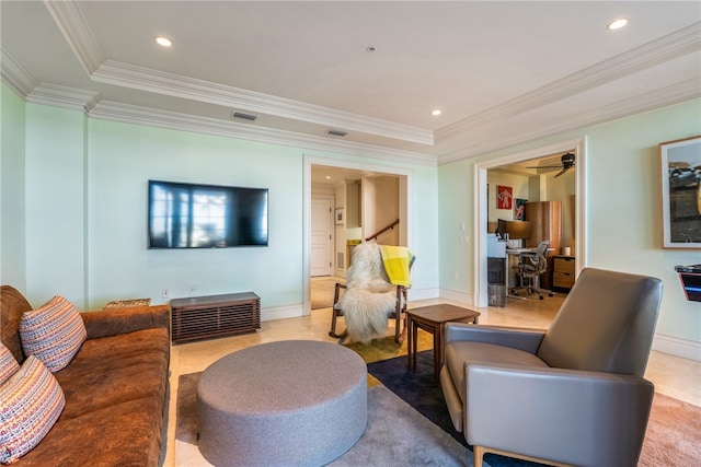 living room featuring ceiling fan, a raised ceiling, and crown molding