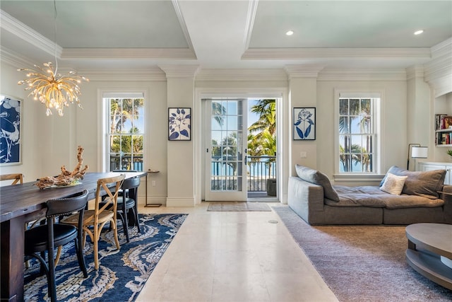 dining area featuring a raised ceiling, crown molding, french doors, and a chandelier