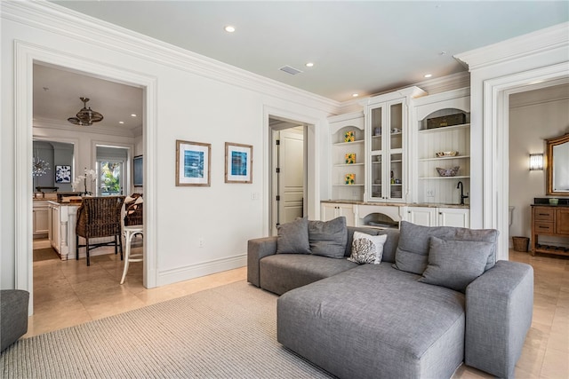 living room with sink, ceiling fan, crown molding, and light tile patterned flooring