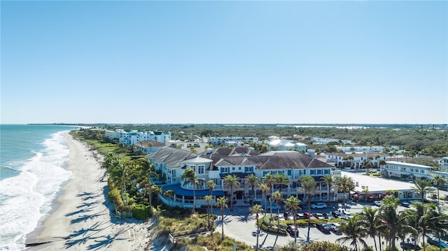 aerial view with a water view and a beach view