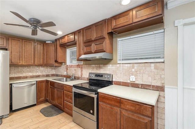 1751 5th Ct, Vero Beach, FL 32960 - kitchen featuring stainless steel appliances, a sink, a ceiling fan, light countertops, and light wood-style floors