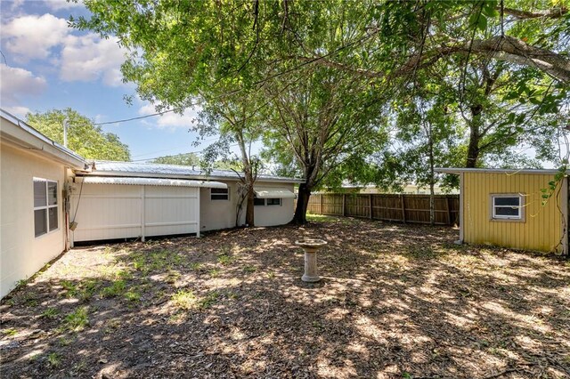 1751 5th Ct, Vero Beach, FL 32960 - view of yard with fence, an outbuilding, and a storage unit