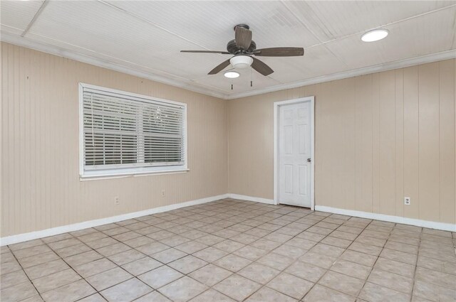 1751 5th Ct, Vero Beach, FL 32960 - spare room featuring a ceiling fan, wooden walls, baseboards, and crown molding
