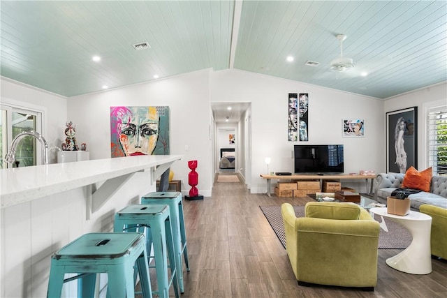 living area with baseboards, wooden ceiling, wood finished floors, vaulted ceiling, and recessed lighting