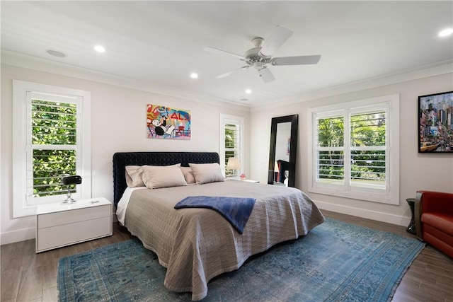 bedroom with multiple windows, baseboards, crown molding, and wood finished floors