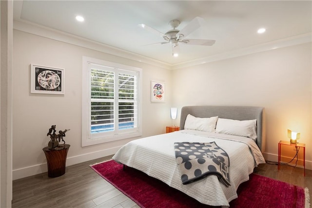 bedroom with ornamental molding, recessed lighting, wood finished floors, and baseboards