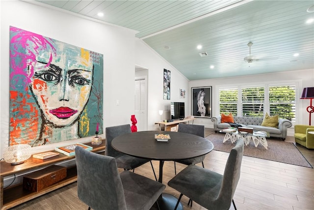 dining area with recessed lighting, wood finished floors, visible vents, vaulted ceiling, and ornamental molding