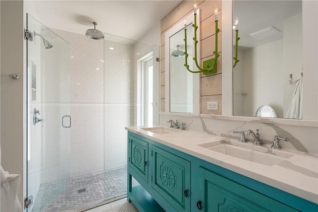 bathroom with double vanity, a sink, and a shower stall