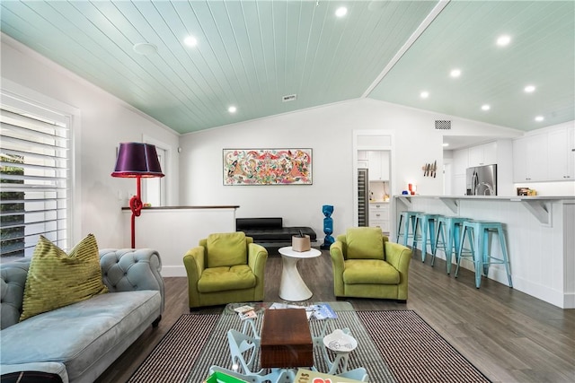 living area featuring recessed lighting, visible vents, vaulted ceiling, and wood finished floors