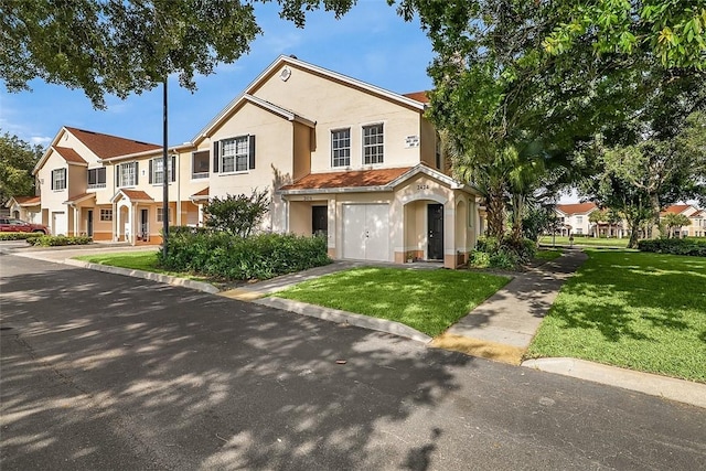 2416 57th Cir Unit 2416, Vero Beach, FL 32966 - view of property with stucco siding, a front yard, a garage, and a residential view