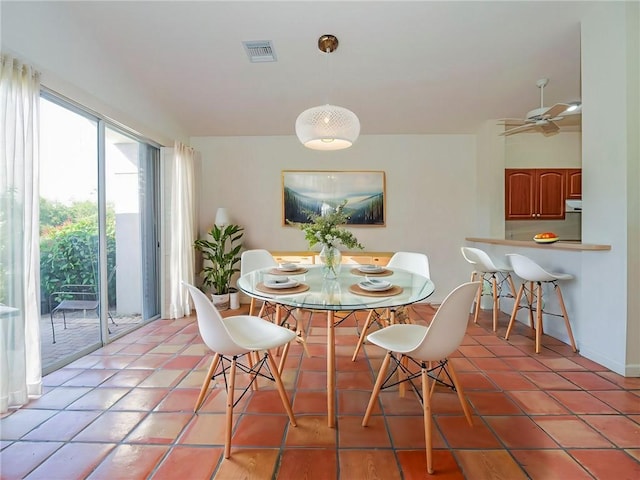 tiled dining space with ceiling fan