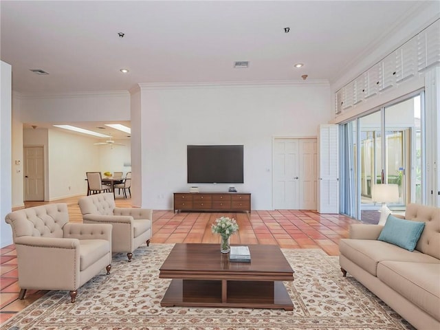 living room featuring tile patterned floors, ceiling fan, and crown molding