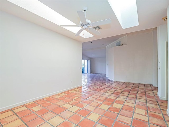 unfurnished room featuring ceiling fan, light tile patterned flooring, and lofted ceiling with skylight